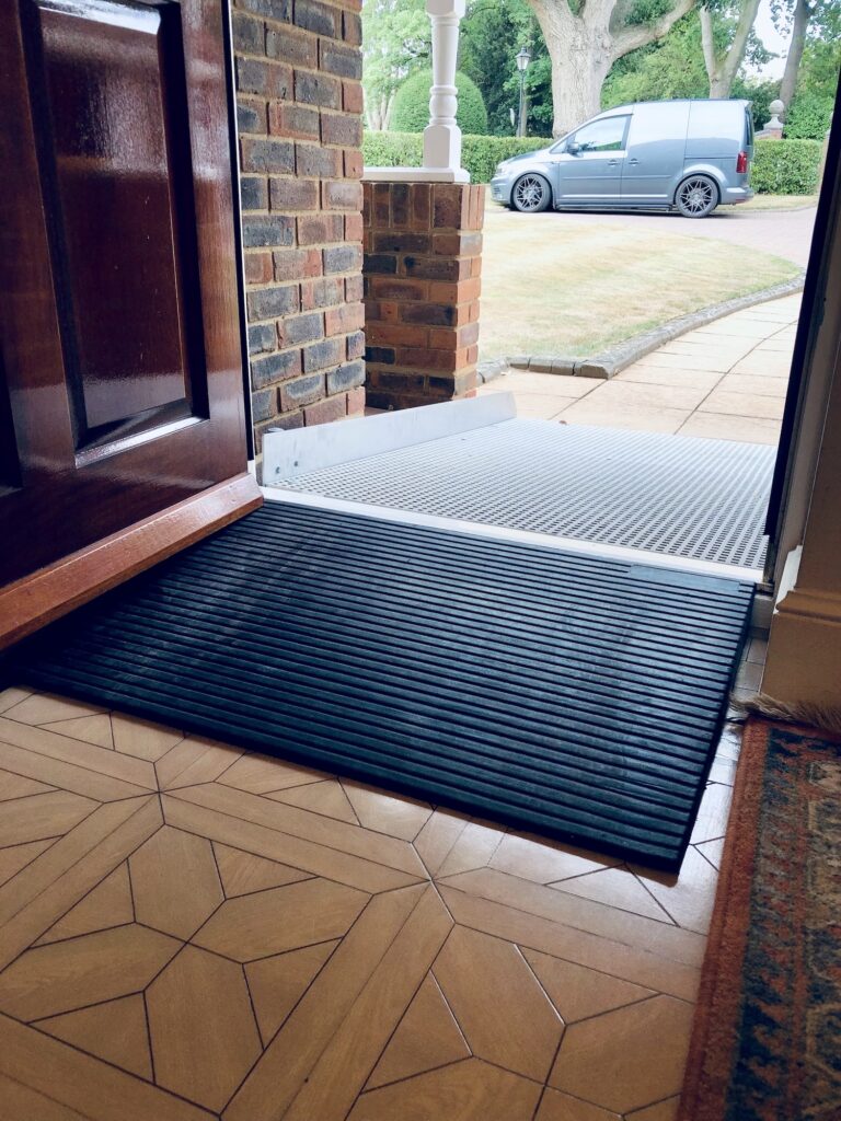 Threshold wheelchair ramp providing step-free access to a front door at a residential property in Warwickshire