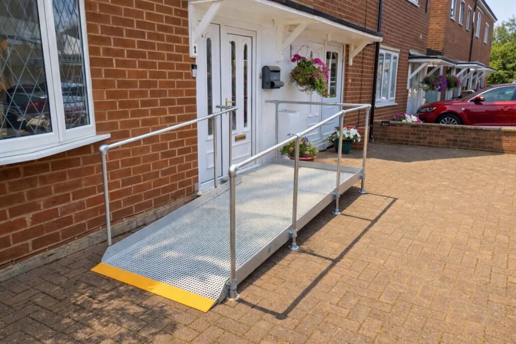 Bespoke modular wheelchair ramp with safety handrails fitted to a home in Southam, Warwickshire.