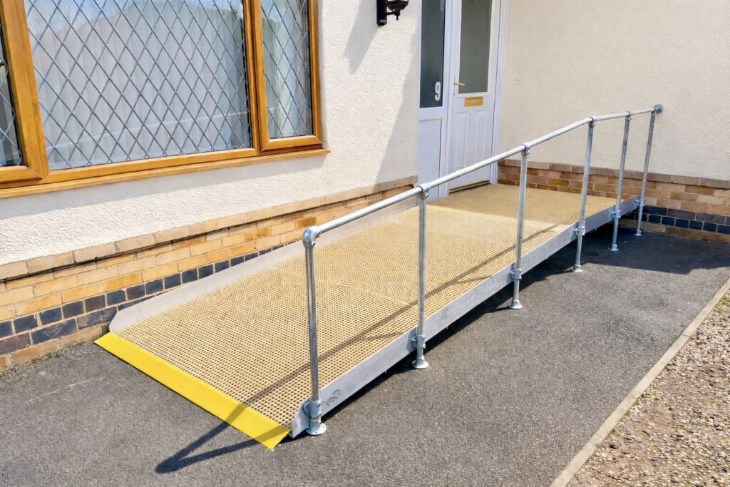 Modular wheelchair access ramp with handrails installed at a residential Kenilworth, Warwickshire.