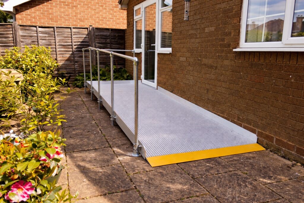 Modular wheelchair access ramp with handrails installed at a residential property in Moreton-in-Marsh.