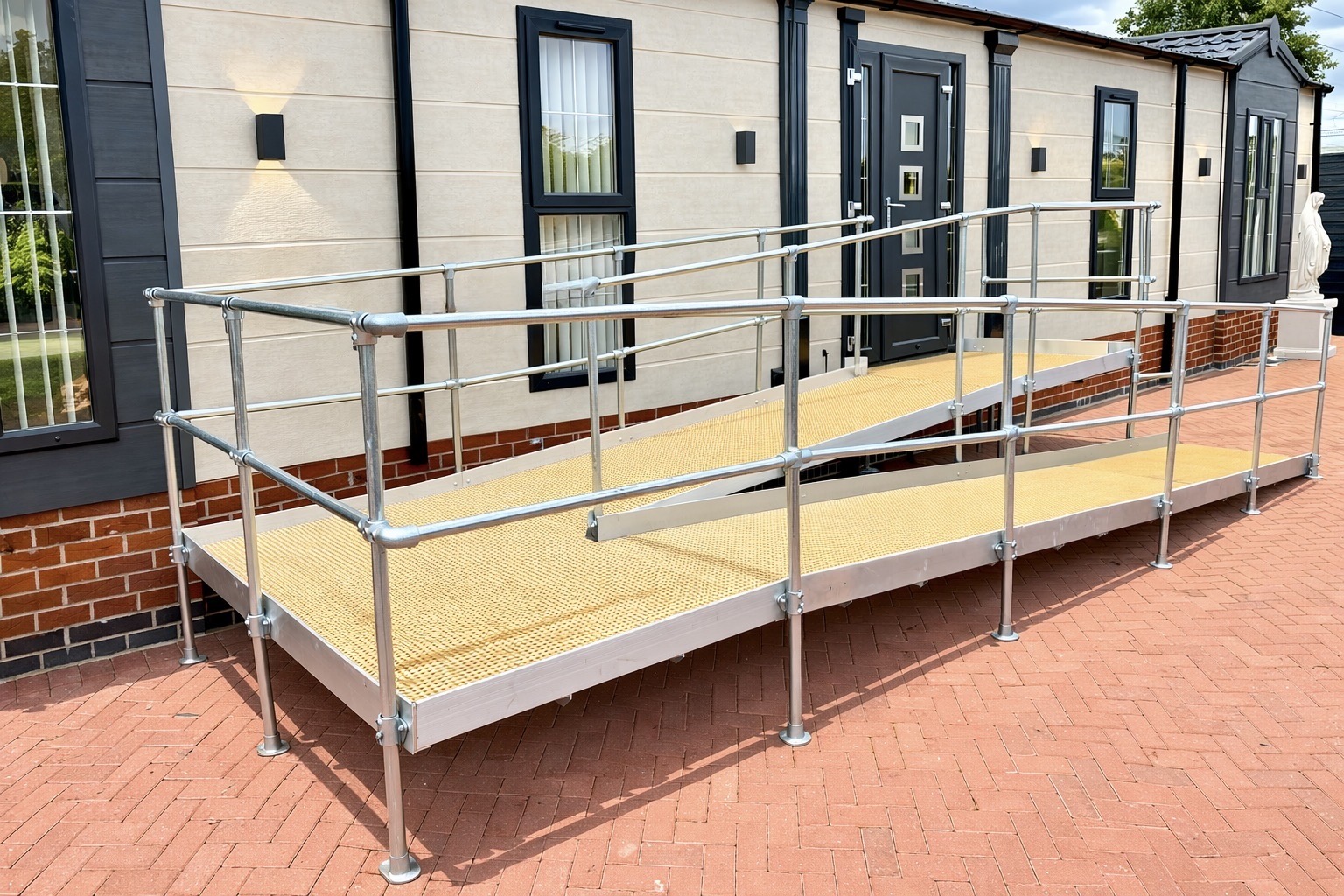Bespoke modular wheelchair ramp with safety handrails fitted to a home in Heartshill, Atherstone.