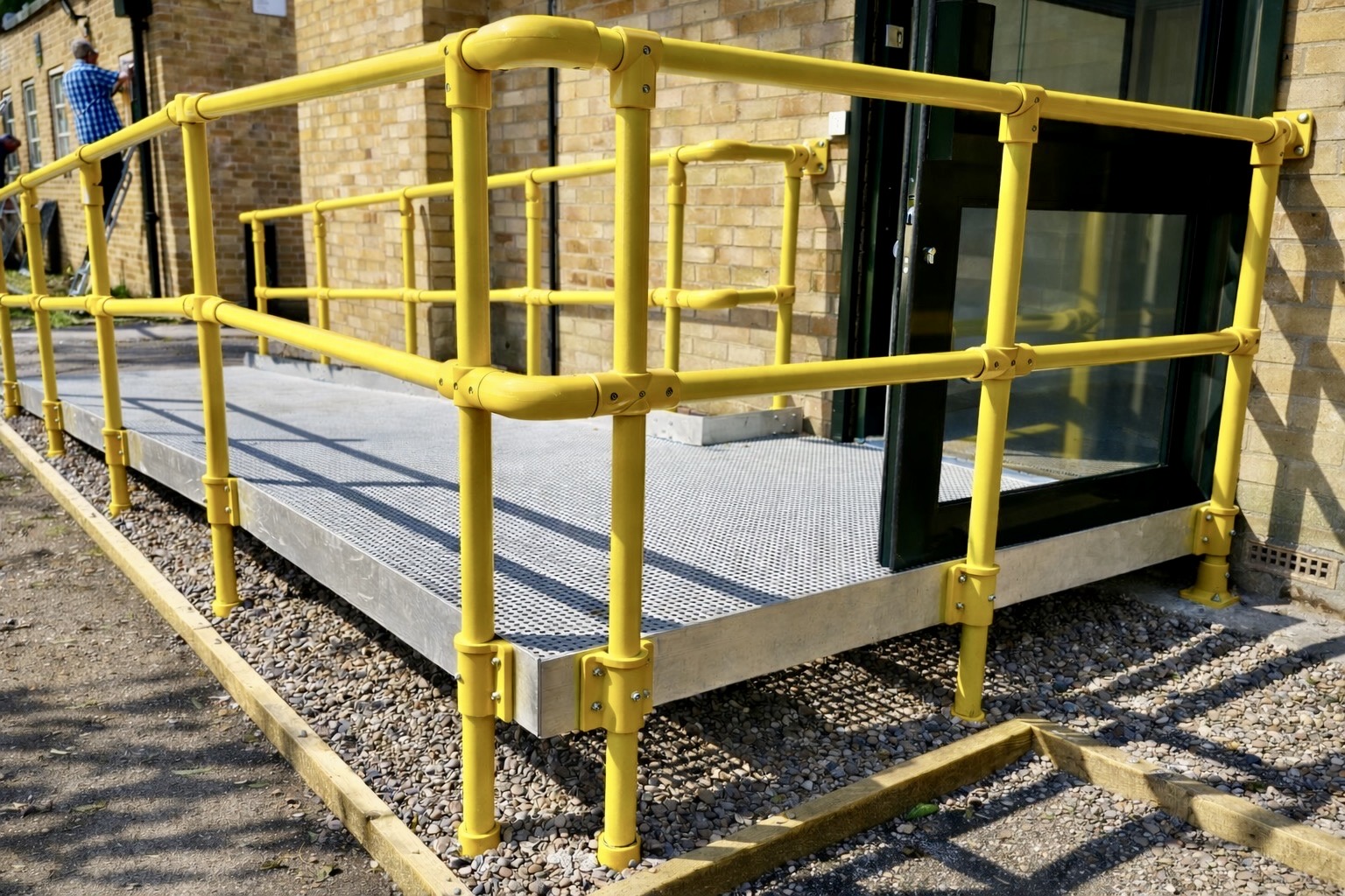 Bespoke modular ramp with safety handrails installed at a community centre in Alcester.